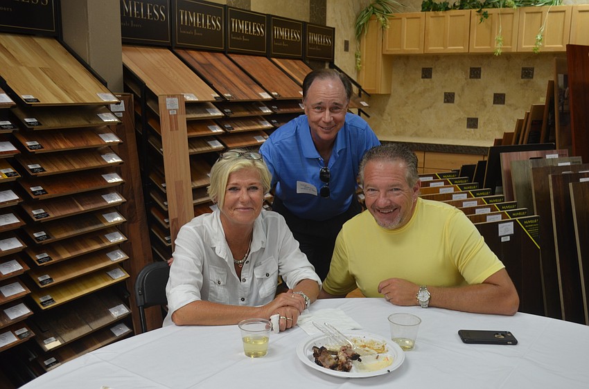 Rita Roser, of Action Realty, David Gutridge, of Friends of Tennis, and Daniel Matusiak, of Action Realty