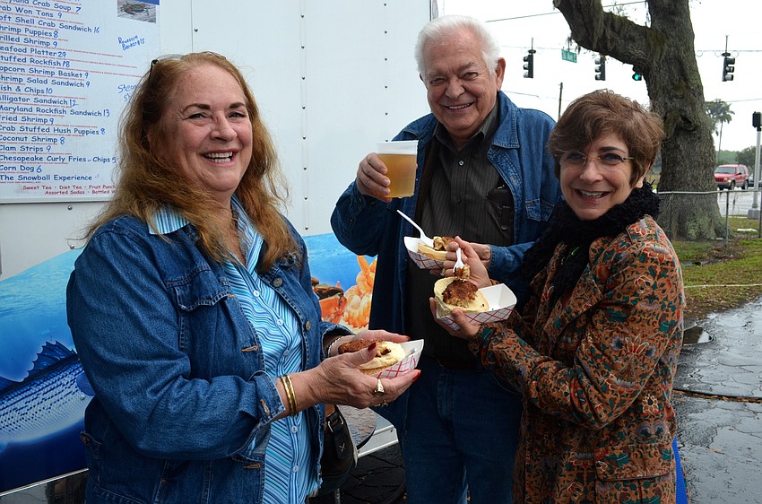 Lawanna Hall, Rolf Kopp and Judy Howell snack on seafood and enjoy time with friends.