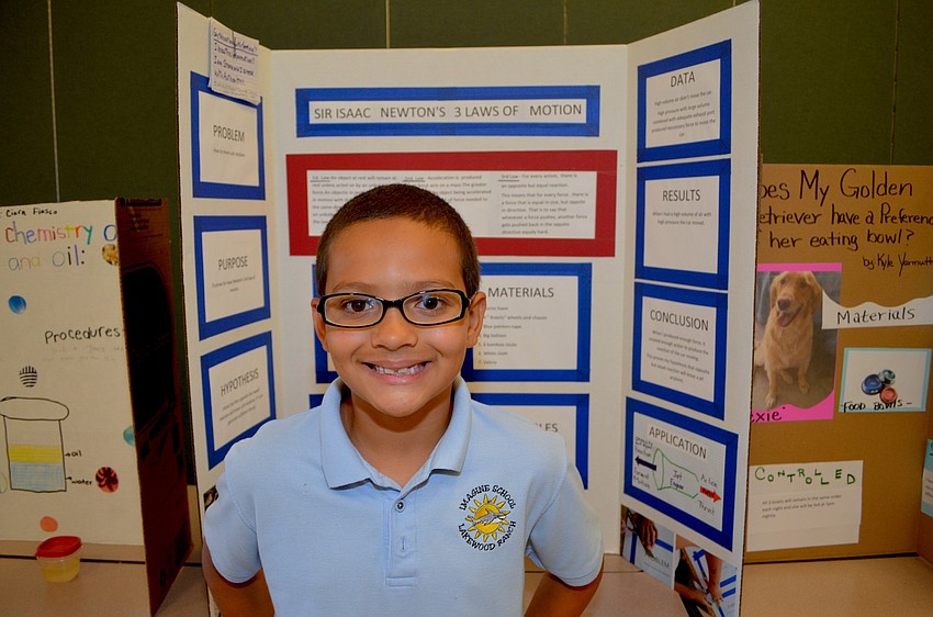 Dante Cayer-Adams, 8, showcases his project on Sir Isaac Newton's three Laws of Motion.
