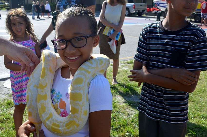 Mackenzie Coulter shows her brave side as she wears a living necklace — a snake from Sarasota Jungle Gardens.