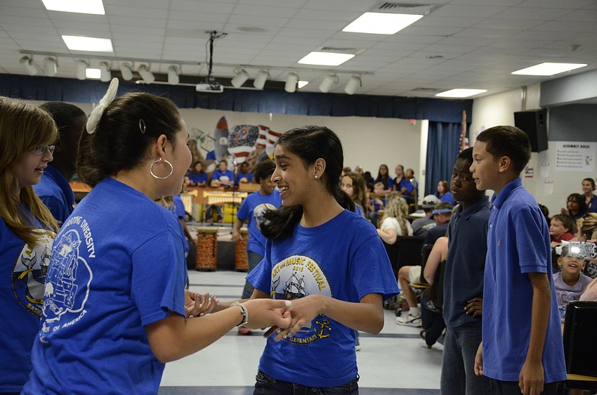 Jolene Tison and Fernanda Ramos, two fifth-graders, dance the Virginia reel.