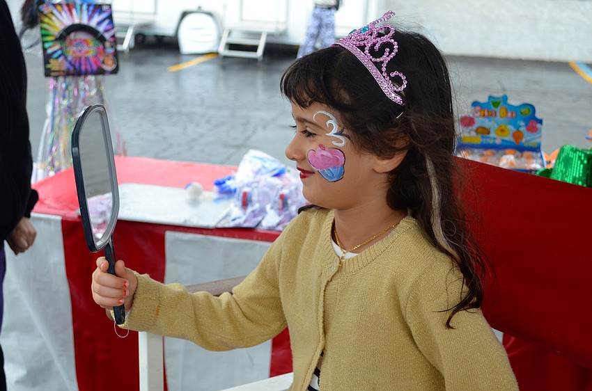 Nora Moradi, 5, raves about the cupcake face paint she sports.