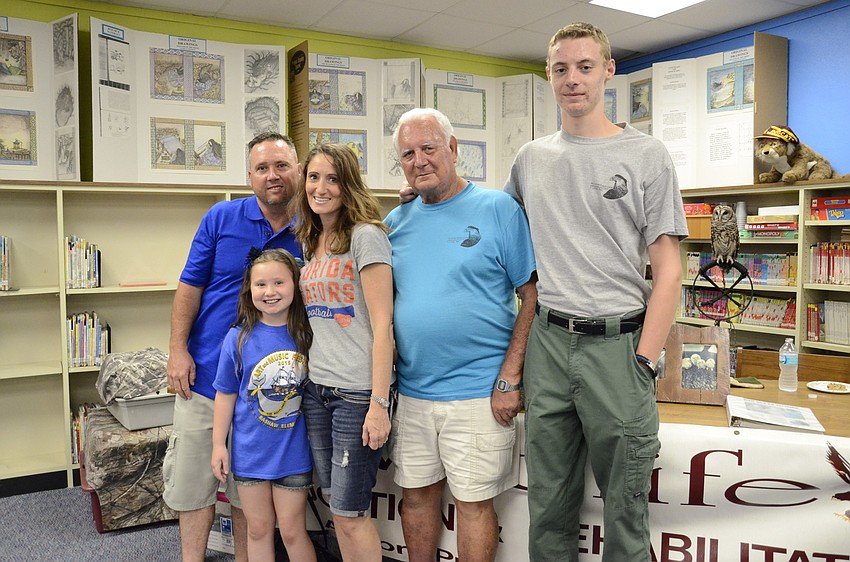 Richie, Sheila and Kailey Cline checked out the owls at Wildlife Inc.'s table, which was watched over by owners Ed and Devon Straight.