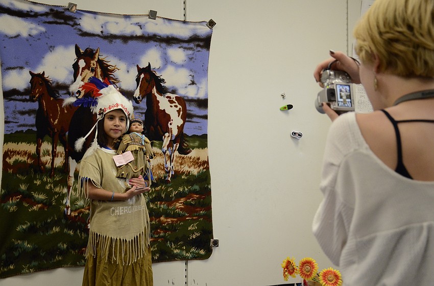 Valeria Marina dresses up as a chief while Maggie Zanders take her photo at the photo booth.