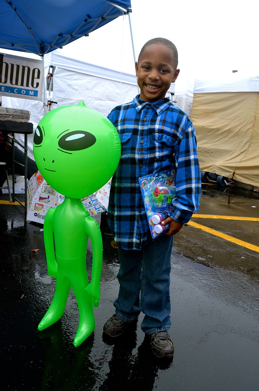 Collin Pierre shows off his loot he won and bought at the event.