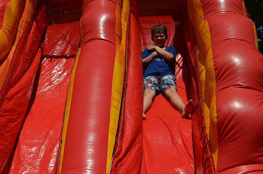 Kieran Malone slides down one of the two water slides for students to enjoy.