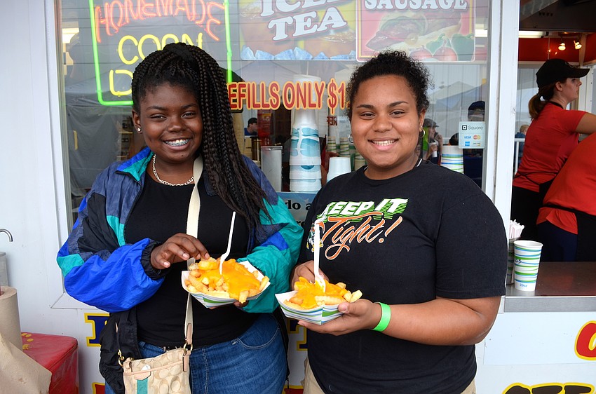 Janae Pompey-Hodo and Amara LeBoff enjoy their hot treats on a chilly afternoon.