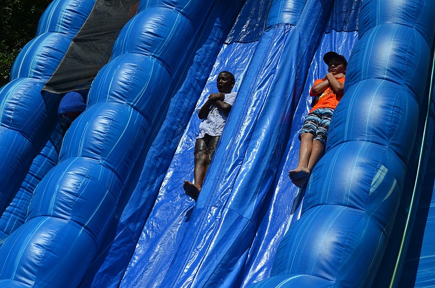 Sonny Jenkins and Gabriel Gonzalez slide down the water slide.