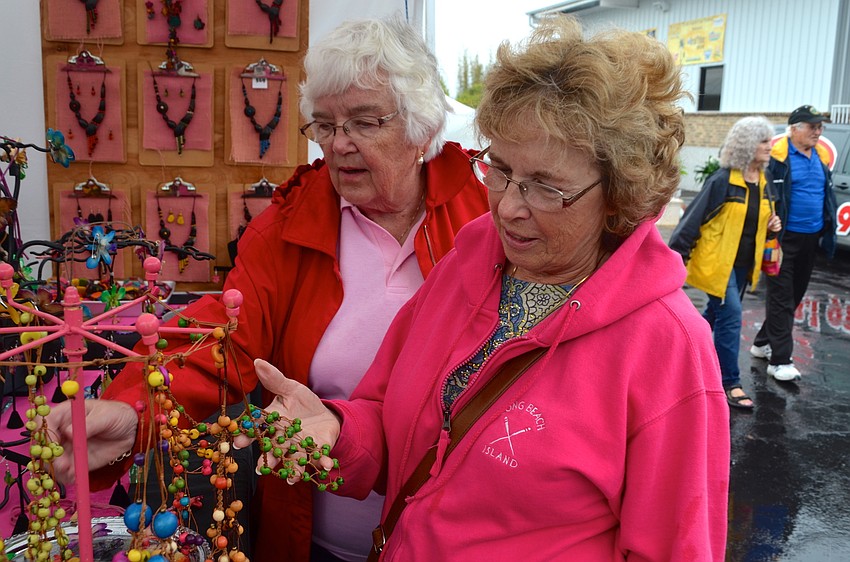 Carolyn Ruban and Susan Hauge browse jewelry at the Gypsy Rose Studios booth.