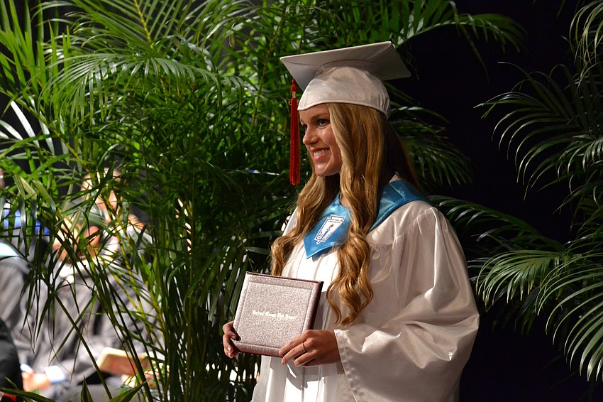 Madeline Del Medico poses for a photo after receiving her diploma.