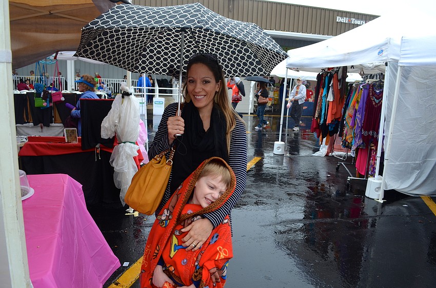 Kris Rummings and her son, Adam, browse the vendors’ items for sale.