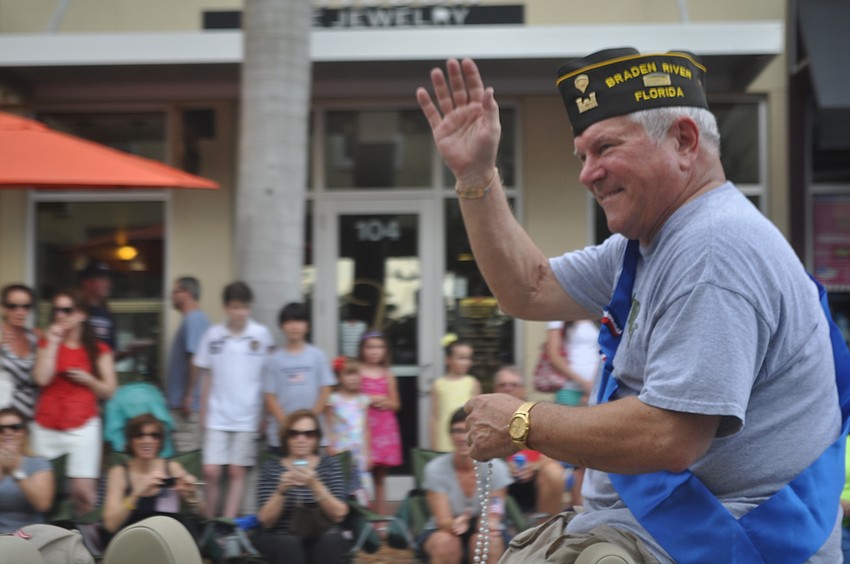 Benjie Brinkofski, the grand marshall of the parade, waves to the crowd.