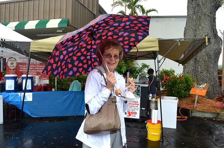 Kathie VanVoorhis keeps her clothes and ice cream cone dry.