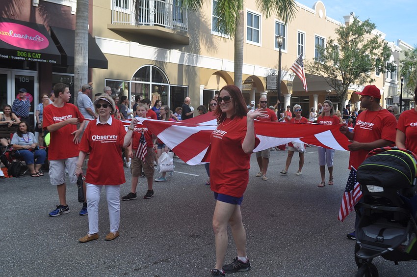 The Observer Media Group carried the flag for the parade.