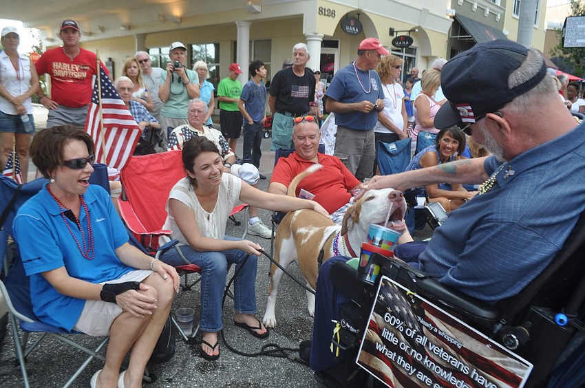 Lindsay Harness, Danielle Troiano and mastiff mix Satchel thank Ray Lesoine for his service.