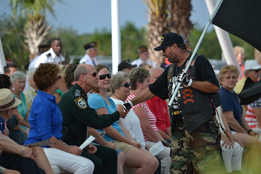 President of the POW MIA Sarasota Chapter Frank d'Antonio greets veterans and family members in the audience.
