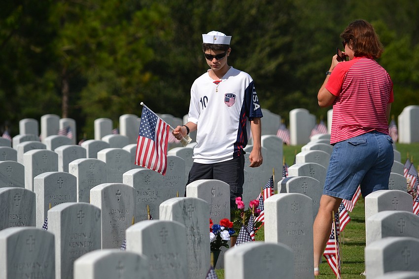 Lisa Cece and her son Michael place flowers for her father Burt Pryor.