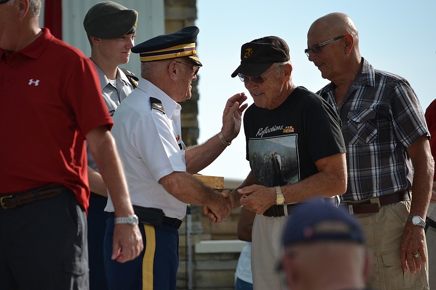 Vietnam veteran Tom Smith receives a commemorative pin for the 50th anniversary of the Vietnam War.