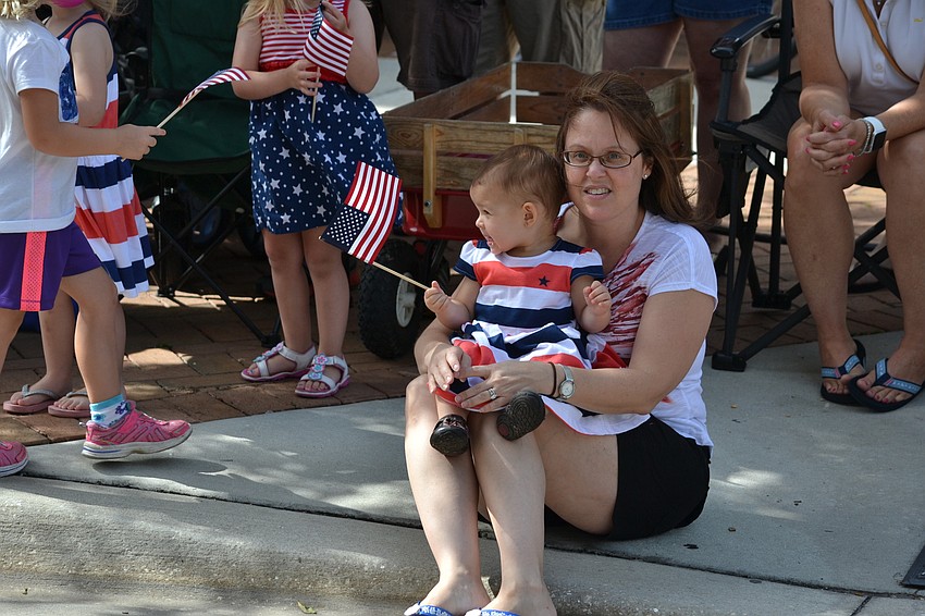 Melissa Smith sits with her daughter Jordyn at the start of the parade.