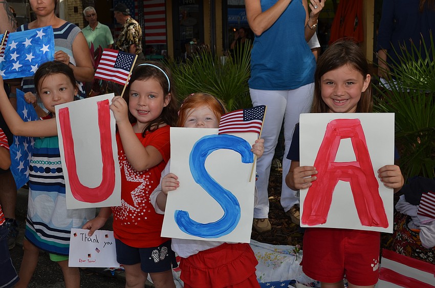 Riley Ellis, Jenna Bates, Delaney Arnold and Jordan Bates made signs to show their support for the Memorial Day Parade.