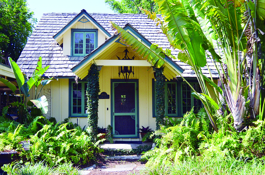 The cottage, built in 1940, reflects the old-fashioned charm of Southside Village. Ivy clad pillars frame the front porch. Photos by Heather Merriman
