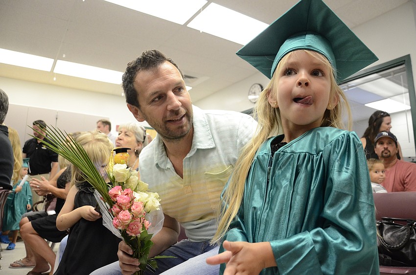 Gabor Sztuska gives his daughter, Luella, a bouquet.