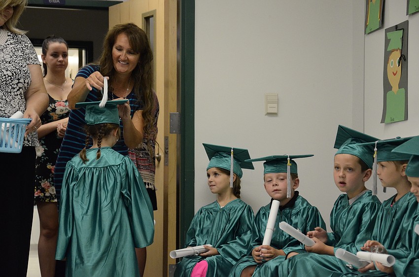 Christina Mohr turns the students' tassles.