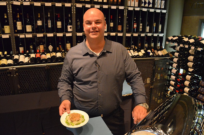 Josh Halbrucker of Duval’s holding a roasted Dijon and cornbread encrusted salmon.