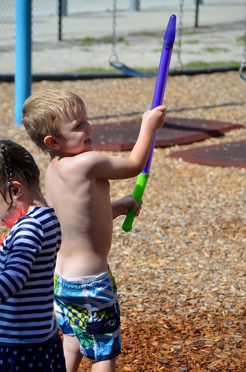 Anthony Marchione looks for the next victim of his water-filled squirt gun.