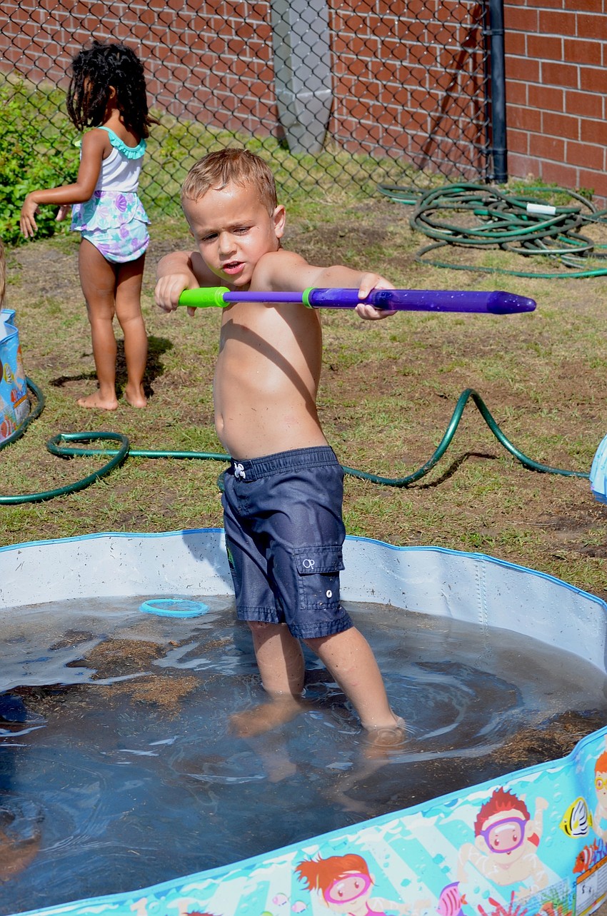 Caden McClusky launches water across the field.