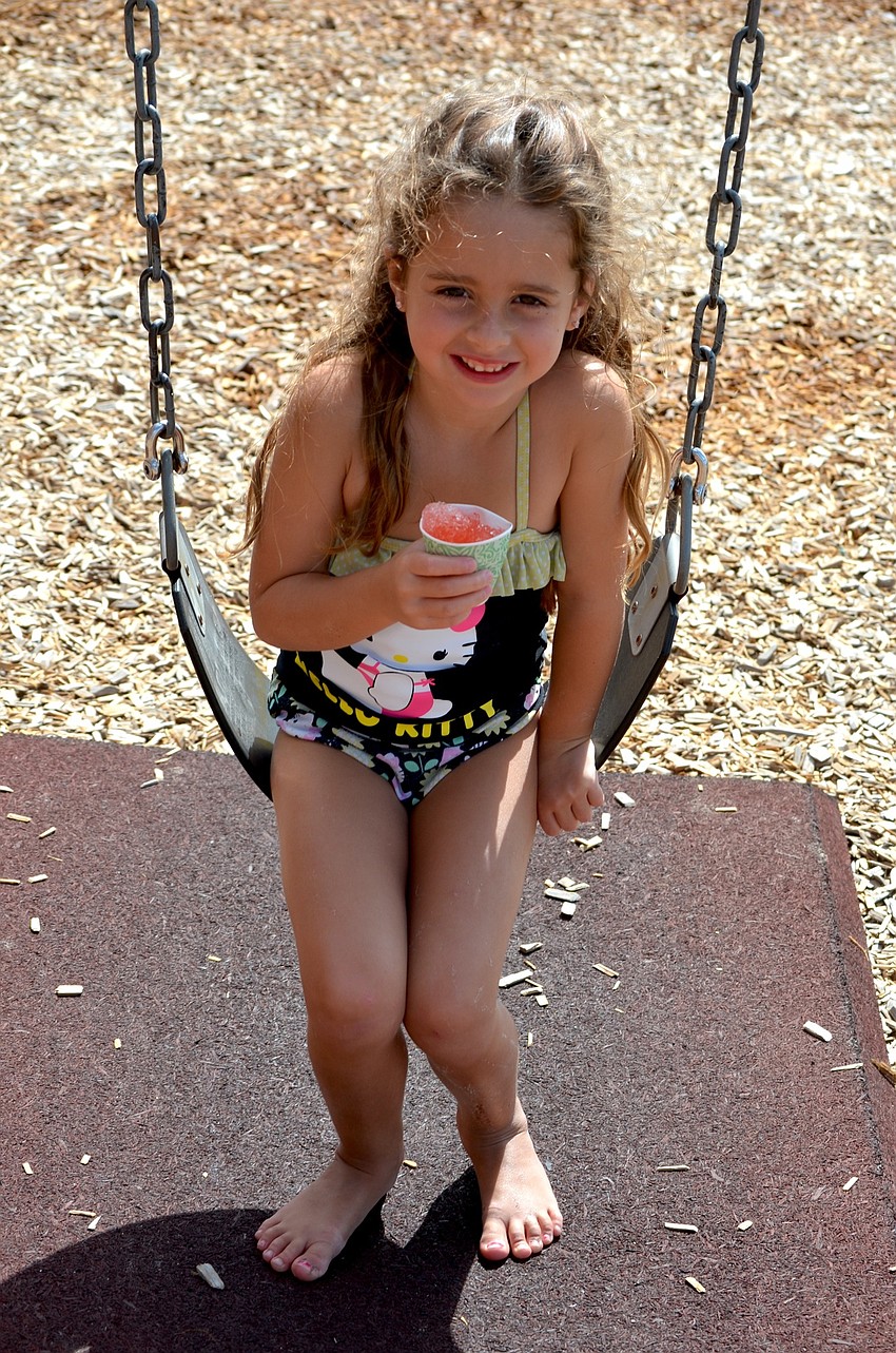 Hailey Perri enjoys a cold snack on a hot day.