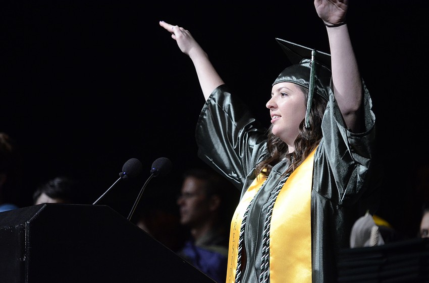 Bailee French, class president, asks everyone to sit before beginning her speech.