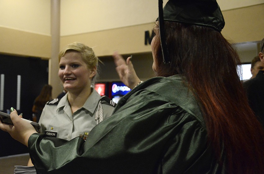 Paige Fuiks, right, fans Cheyenne Gibson's face to help her keep from crying.
