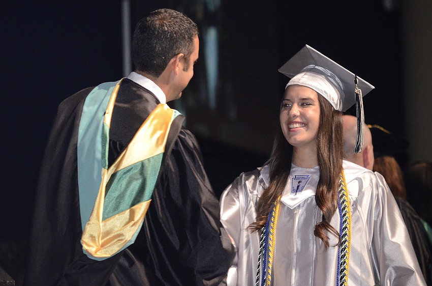Kaitlyn Konieczny shakes Principal Craig Little's hand before receiving her diploma.