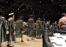 Students walk to their seats in the convention center.