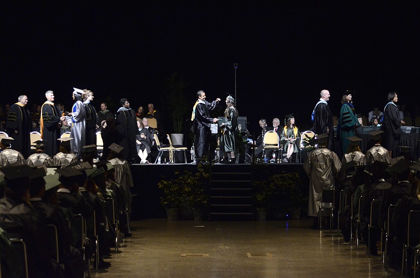 Principal Craig Little turns tassels.