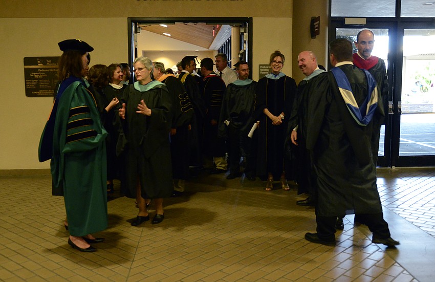 Teachers and faculty line up to lead the graduates into the ceremony.