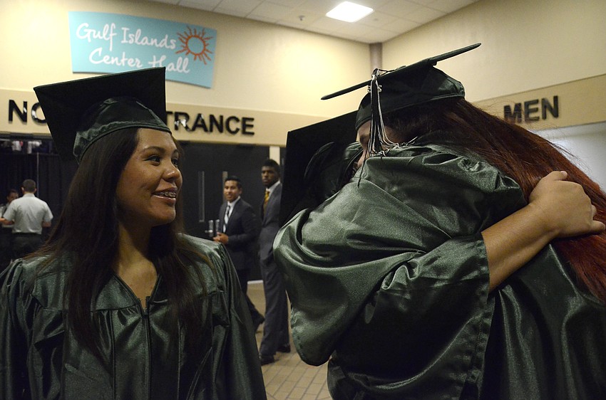 Yesenia Zamarripa watches her friends Audriana Montez and Paige Fuiks hug before the ceremony.