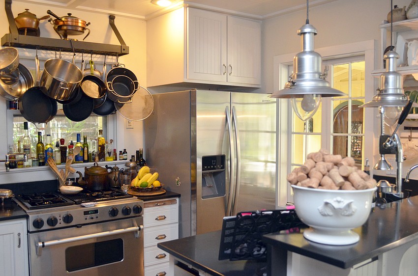 The kitchen is also on the small side, but careful planning gives it the efficiency of a ship’s galley. The counters are black slate, adding a dramatic touch.