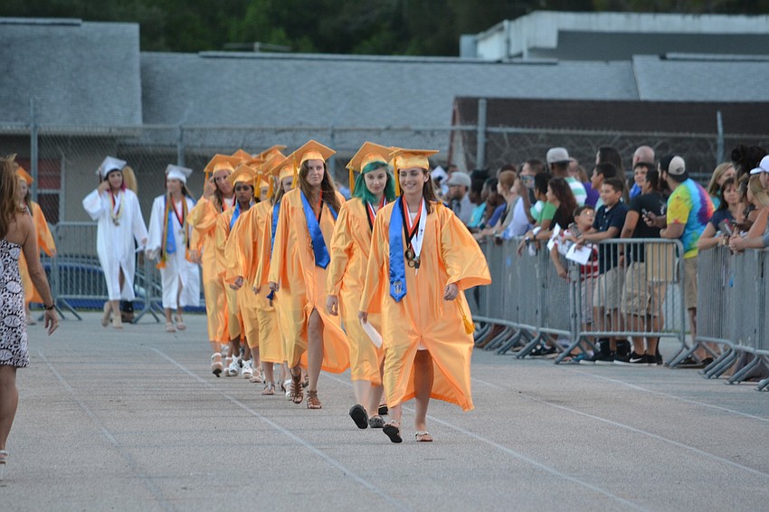 Students with AP Highest Honors (a GPA of 4.5 with five AP Honors Courses) wore gold caps and gowns.