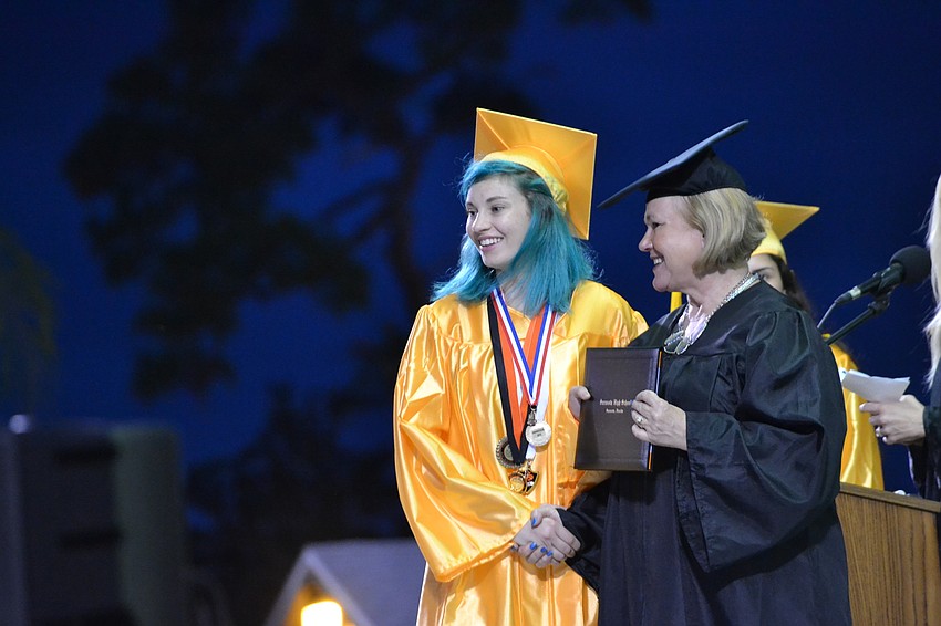 Rebecca Elsishans crosses the stage to receive her diploma.