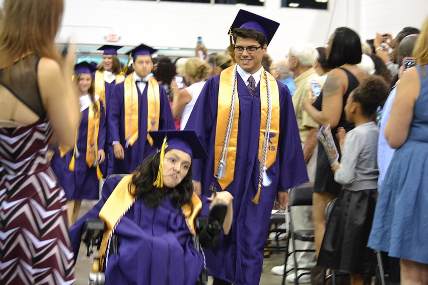 Eileen Torres and Pablo Infante lead the procession of students into Robarts Arena.