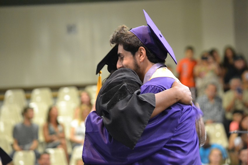 Booker High School Principal Rachel Shelley hugs student Ryan O’Dell.