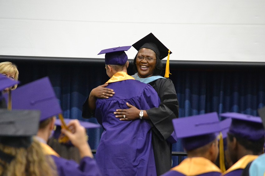 Principal Rachel Shelley gave hugs to graduates as they received their diplomas.