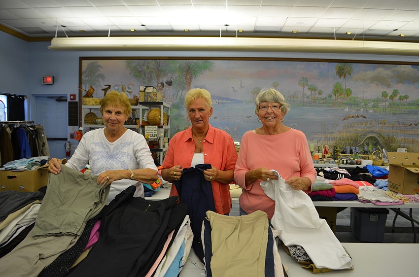 JoAnne Entwistle, Linda McKay and Sue Troup fold clothing to be sold at St. Mary’s annual Rummage Sale.