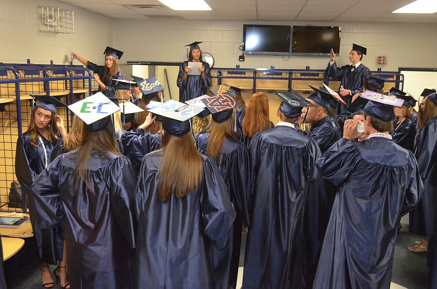 Many students decorated their graduation caps with their university’s logos.