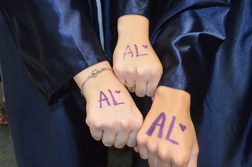 Each student wore a purple ribbon and wrote the initials “AL” on their hand to honor classmate Annika Lange, who died Sept. 18.