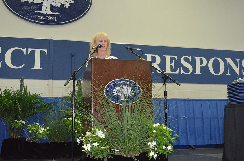 Mitzie Henson, Chair of the Board of Trustees, speaks.