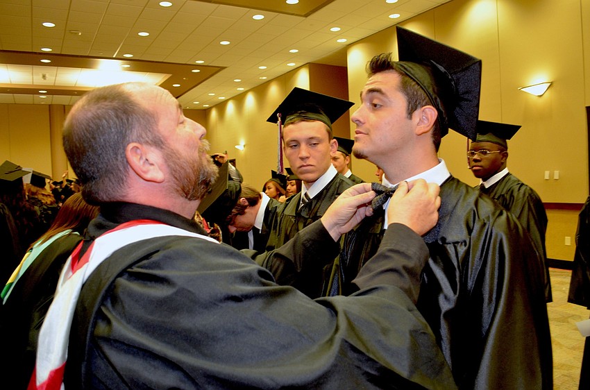 Assistant Principal Don French helps Dan Quijano straighten his bow tie.