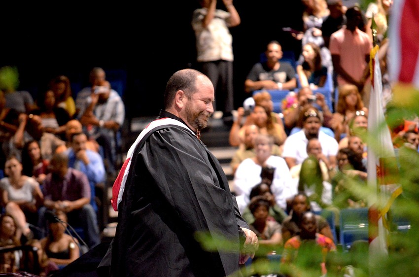 Assistant Principal Don French welcomes the crowd to the ceremony.